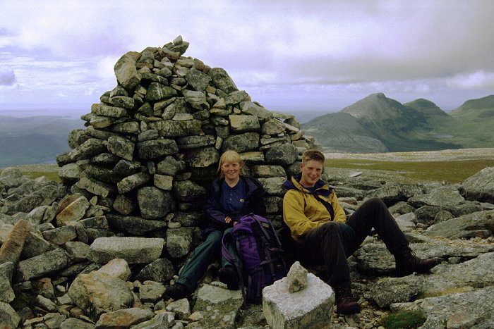 Summit cairn with ridges of Quinag behind