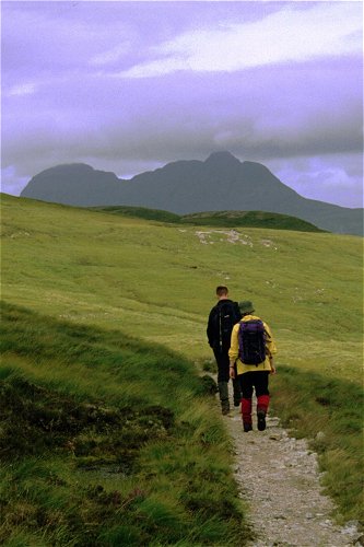 Susan and Andrew on the approach path, Suilven beyond